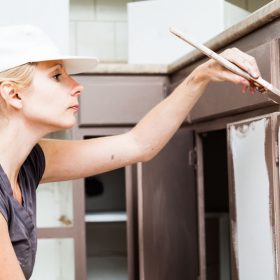 woman painting kitchen cabinets